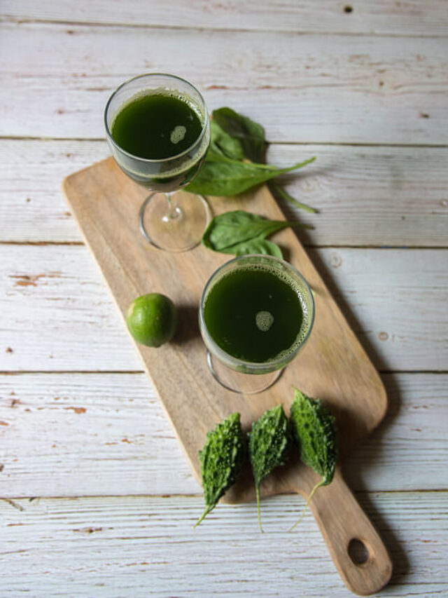 Top view of vegetable juice in a glass on a wooden board